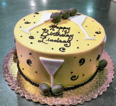 a yellow birthday cake sitting on top of a table