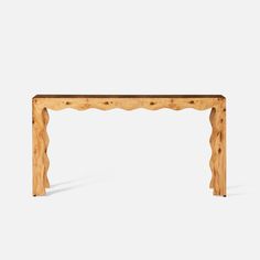 a wooden table with scalloped legs