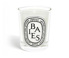 a glass candle with the words bakes printed on it and an oval design in black