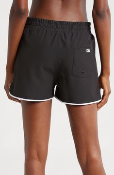 A '90s-inspired lace-up closure and dolphin hem bring some extra fun to these stretchy, high waist board shorts featuring built-in sun protection for the win. 2 1/2" inseam Zip fly with snap closure; lace-up closure Front slant pockets; back patch pocket with drainage grommet UPF 50+ sun protection 92% recycled polyester, 8% spandex Machine wash, tumble dry Imported Sporty Swim Trunks With Built-in Shorts, Black Athleisure Bottoms For Summer, Nylon Bottoms With Built-in Shorts For Beach Season, Moisture-wicking High-waisted Shorts For Beach, Black Nylon Shorts For Beach Season, Sporty Relaxed Fit Shorts For Beach Season, Black Bottoms With Built-in Shorts For Beach Season, Short Length Bottoms With Drawstring And Adjustable Waist, Black Drawstring Bottoms For Beach Season