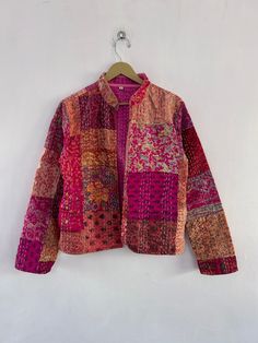 a colorful jacket hanging on a white wall