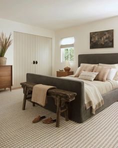 a bedroom with a bed, dresser and chair in it's centerpieces