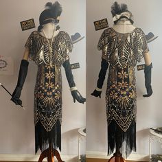 two mannequins dressed in black and gold clothing