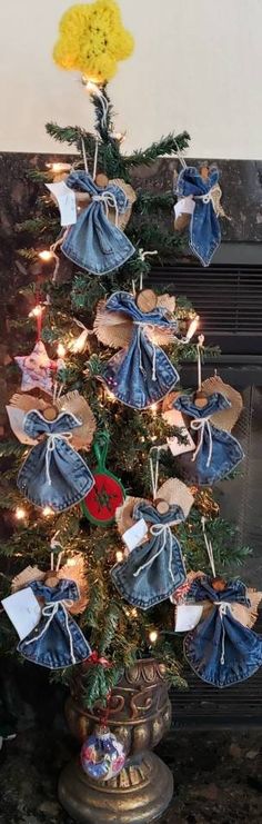 a christmas tree decorated with blue jeans and yellow flowers