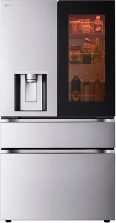 a silver refrigerator freezer sitting next to an oven with its door open and shelves full of bottles