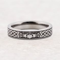 a wedding band with an image of a crab and heart on the inside of it