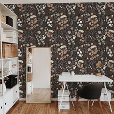 a white desk sitting next to a book shelf on top of a hard wood floor