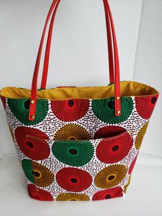 This is a carefully crafted bag made from African Print Kente cloth and it can be used for everyday uses, such as church, market, work, and school activities. Large Capacity Fabric Canvas Tote Bag, Green Tote Diaper Bag For Daily Use, Canvas Tote Shopping Bag, Green Fabric Bag For Daily Use, Green Fabric Bags For Daily Use, Everyday Fabric Tote Shoulder Bag, Yellow Fabric Tote Bags, Yellow Fabric Everyday Bag, Fabric Tote Bag For Everyday Use