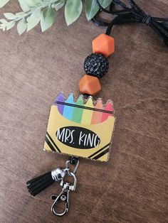 Perfect gift to give a special teacher to show your appreciation for them! 🔅DUE TO RETRACTABLE REEL, RING CAN NOT HOLD A LARGE NUMBER OF ITEMS. USE PICTURE AS A GUIDE.  * Q U I C K * F A C T S * 🔅 This listing is for one Crayon Badge Reel Lanyard 🔅 All products are handmade 🔅Material: Acrylic, Silicone Beads, Satin Nylon Cord, Acrylic Disk 🔅 Color of Key Ring: Silver- Msg for other options 🔅Color of Vinyl: Writing will be White 🔅 Size: Approximately: Lanyard measures about 23 inches from clasp to the end of maple disk.  🔅 Vinyl is sealed with Epoxy for durability  🔅 Please note: these keychains are not dishwasher safe, microwave safe, and they cannot soak in the sink. 🔅🔅Personalization will be added to disk EXACTLY how it is written on personalization section. So please double c Adjustable Fun Badge Holders For Gifts, Adjustable Multicolor Badge Reel For Gift, Adjustable Multicolor Badge Reel For Gifts, Novelty Adjustable Badge Holders For School, Personalized Multicolor Badge Holders For School, Personalized Black Lanyard For Gift, Personalized Black Lanyards For Gifts, Personalized Adjustable Black Badge Holders, Personalized Black Lanyards As Gift