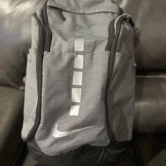 Nike Unisex-Adult Elite Backpack With Run Vest * Large, Zippered Main Compartment Provides Space For Your Gear. * Ventilated Shoe Compartment Can Hold Up To A Size 15. * Nike Pro Adapt Shoulder Straps Provide Comfort. * Zippered Foil-Lined Pocket Offers Space For Your Favorite Beverage Nike Rectangular Backpack For Sports, Nike Sports Backpack Rectangular, Nike Rectangular Sports Backpack, Gray Nylon Rectangular Backpack, Gray Rectangular Nylon Backpack, Functional Gray Backpack For Sports, Functional Gray Sports Bag, Functional Gray Sports Backpack, Sporty Gray Sports Bags