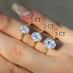 three caramel colored diamond rings are shown in front of the finger size chart for each ring