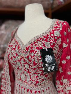 Rose red decorated with silver zari thread embroidery on the surface of the anarkali and highlighted in sequence and resham work. Paired with thread and sequence embroidered dupatta. Fabric: Georgette Size: 40/L Occasion: Wedding Events WASH CARE INSTRUCTIONS - Please Dry clean only when it is applicable. Slight color variation is possible due to photography Ready to Ship! Silver Anarkali Set For Eid, Bollywood Silver Anarkali Set With Dabka Work, Silver Anarkali Salwar Kameez With Dabka Work, Silver Anarkali Set With Zari Work, Festive Silver Embroidered Anarkali Set, Silver Embroidered Bollywood Anarkali Set, Red Anarkali Gown With Intricate Embroidery, Traditional Red Gown With Mirror Work, Bollywood Style Silver Embroidered Anarkali Set