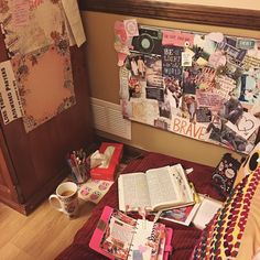 a room with a bed and many papers on the floor next to a wall covered in pictures