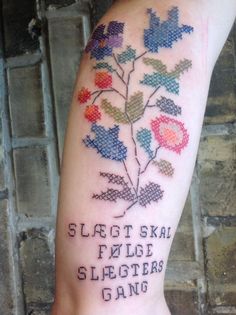 a person with a tattoo on their arm that says sleagt skat false sleeters gang