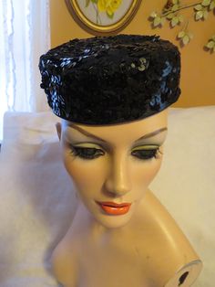 "1960s' ladies black sequin small head top hat with large black velveteen bow, by designer Yves Saint Laurent. This cocktail hat is 2\" tall, with a 9\"X 1 1/2\" bow on the back side of it, and a tiny elastic band to hold it to your head top. I myself would style this cutie with the bow in the front or in the back. Hats' circumference fit is 21 1/2\", and it is in good condition. PRICE IS $295.00----SALE FINAL/AS IS/NO RETURNS." Fitted Vintage Costume Hats And Headpieces For Party, Vintage Top Hat With Short Brim For Party, Retro Cloche Costume Hats And Headpieces For Party, Vintage High Crown Fascinator For Party, Retro Black Costume Hats And Headpieces For Party, Vintage Cloche Costume Hat For Party, Retro Fitted Mini Hat For Evening, Vintage High Crown Mini Hat For Parties, Retro Cloche Mini Hats For Party