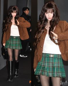 a girl with long brown hair wearing a green plaid skirt