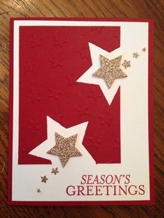 a red and white card with stars on the bottom, says season's greetings