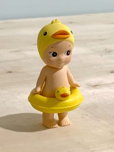 a small toy duck sitting on top of an inflatable float