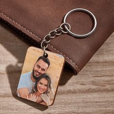 a couple keychain with a photo on it