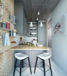 two stools sit in front of a kitchen island with wooden counter tops and shelves