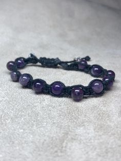 Round Amethyst beads braided in black cord. Bracelet is adjustable, just pull both cords! Silver cylinder beads for pulling. Adjustable Purple Beaded Bracelets With Sliding Knot, Black Adjustable Braided Bracelets With Round Beads, Adjustable Black Braided Bracelet With Round Beads, Adjustable Hand-strung Amethyst Beaded Bracelets, Adjustable Purple Beaded Bracelet, Adjustable Purple Beaded Spiritual Bracelets, Adjustable Amethyst Beaded Bracelet, Adjustable Resizable Purple Bracelets, Adjustable Purple Spiritual Beaded Bracelets