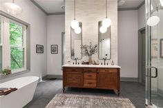 a large bathroom with two sinks and a bathtub