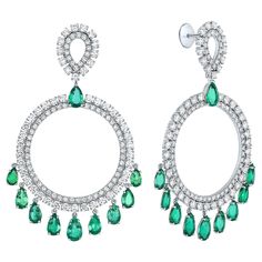 Introducing a breathtaking matched pair of 18K White Gold, Emerald, and Diamond Circular Drop Earrings. These exquisite chandelier drop earrings feature pear-shaped emerald stones totaling 9.63 carats and are accented by 216 round brilliant-cut diamonds weighing approximately 7.96 carats. Set in polished 18k white gold, this timeless piece will be a standout addition to any jewelry collection. Our Round With Pear-shape Emerald and White Round And Round Brilliant Diamond Gypsy Earrings boast a di Diamond Supply, Emerald Stone, Rough Diamond, Drop Earring, Brilliant Diamond, Round Brilliant Cut Diamond, Round Brilliant, Pear Shaped, Colored Diamonds