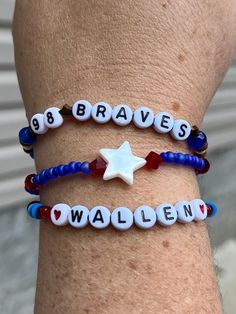 two bracelets with name charms on them that say brave, wallen and 8 braves