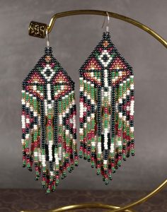 the beaded earrings are hanging from a hoop