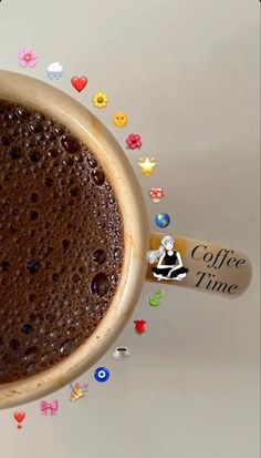 a cup of coffee sitting on top of a table with confetti around it