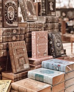 several books are stacked on top of each other in front of a store display case