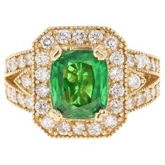 This beautiful ring has a Cushion Cut Tsavorite that is 3.81 Carats and 40 Round Cut Diamonds that weigh 1.38 Carats. (Clarity: VS, Color: F) The total carat weight of the ring is 5.19 Carats. Tsavorite is a natural stone that belongs to the Garnet family of stones. The measurements of the Tsavorite are approximately 9 mm x 7 mm. The ring is beautifully crafted in 14K Yellow Gold and weighs approximately 9.3 grams. It is a size 7 and can be re-sized at no additional cost. Stunning Aesthetic, Tsavorite Garnet, Contemporary Ring, Golden Ring, E 40, Pretty Rings, Beautiful Ring, Jewelry Rings Engagement, Round Cut Diamond