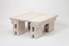 a small white wooden table on a white background