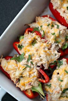 several stuffed peppers in a white casserole dish