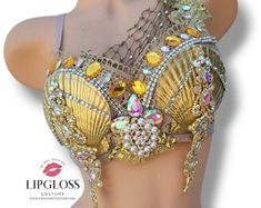 an image of a woman wearing a bra with gold and crystal beads on it's chest