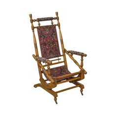 a wooden rocking chair with floral fabric on it's back and seat padding