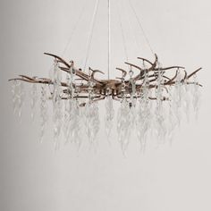 a chandelier made out of antlers and glass beads hanging from the ceiling