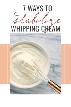 a white bowl filled with whipped cream next to a whisk on top of a marble