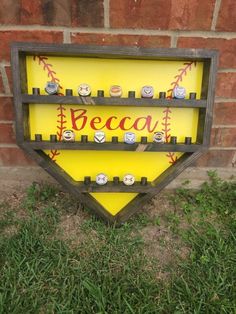 a wooden sign that says beca with baseballs on it