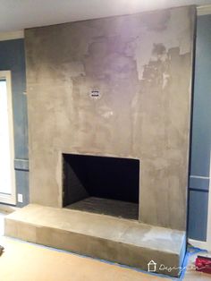 an empty fireplace in the middle of a room