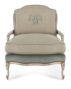 an ornate chair with a monogrammed initials on the back