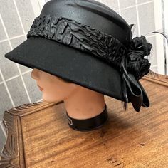 Elevate Your Style With This Classic Black Hat From Something Special. Perfect For Weddings, Parties, And Formal Events, This Hat Is Sure To Turn Heads. The Wool Material And Decorative Flowers Woven Into Satin Ribbon Add An Elegant Touch, While The Vintage Style Gives It Timeless Appeal. One Size Fits Most, Making It A Versatile Accessory For Any Outfit. Whether You Dress Up Or Down, This Hat Is A Must-Have For Any Fashionable Woman. Add It To Your Collection Today And Step Out In Style! Something Special, Ribbon Flowers, Formal Event, Classic Black, Derby, Special Events, Women Accessories, Vintage Fashion, Wool