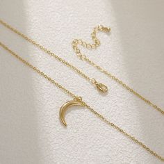 Adorn yourself with celestial grace wearing the Petite Lunar Crescent Pendant. Crafted delicately, this dainty necklace features a miniature crescent moon, a symbol of mystique and intuition. Embrace the allure of the night sky with this elegant accessory, lending a touch of cosmic charm to your style. 18k Gold Plated Stainless Steel Pendant Size - 15mm x 10mm Chain length - 45cm Chain Style - Classic chain Tarnish free / Water resistant 💧 Delicate Crescent Moon Charm Necklace, Elegant Moon Shape Clavicle Chain Necklace, Dainty Crescent Necklace With Delicate Chain, Minimalist Crescent Clavicle Chain Charm Necklace, Minimalist Crescent Charm Necklace With Clavicle Chain, Elegant Moon-shaped Necklace With Delicate Chain, Delicate Half Moon Phase Necklace, Elegant Layered Necklace With Moon Charm As Gift, Elegant Half Moon Charm Necklace