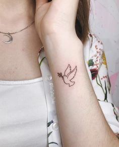 a woman with a small tattoo on her arm