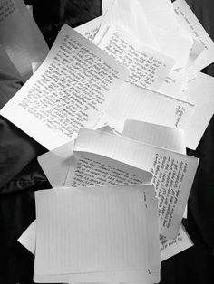 several pieces of lined paper on top of each other with words written on them in cursive writing