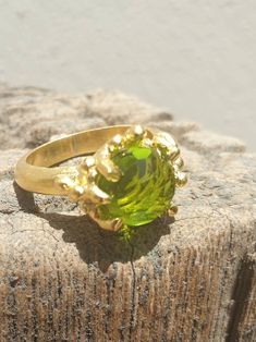 This is gold plated brass peridot ring. A designer handmade ring. It has a design of a coral, holding a green peridot gem. It could be an alternative engagement ring, or a great gift for a loving one. - 14 karat Gold plated brass - Round peridot gem - Free shipping worldwide - Sent in a gift box If you would like to see other rings I have made, please follow this link: https://www.etsy.com/il-en/shop/TamyZurTachshit?ref=seller-platform-mcnav&section_id=17271018 If you would like to go back t Gold Peridot Ring, Engagement Ring Solitaire, Alternative Engagement Ring, Green Gem, Coral Ring, Gifts Fo, Green Gems, Gem Ring, Alternative Engagement Rings