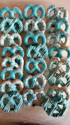 blue and white frosted donuts are on a plate