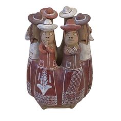 two ceramic figurines with hats on their heads