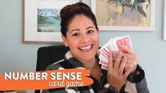 a woman holding up two cards in her hands and smiling at the camera, with an orange text overlay that reads number sense card game