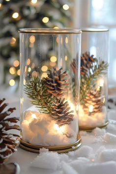 two glass jars filled with pine cones and lights